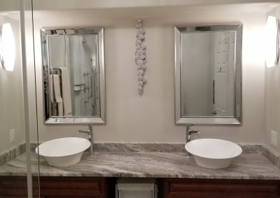 Custom double vanity with feature lighting in bathroom renovation completed by Regional Renovations